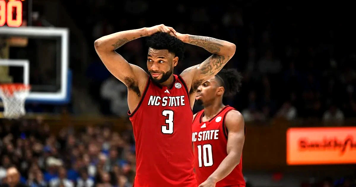 NC State basketball player reacts during a game against a tough opponent.