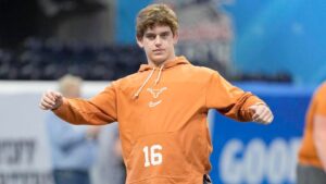 "Texas Longhorns recruit in jersey number 16 poses at an indoor sports facility"