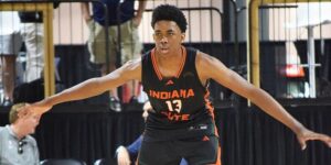 "Indiana Elite player number 13 in action during a basketball game at an indoor court"