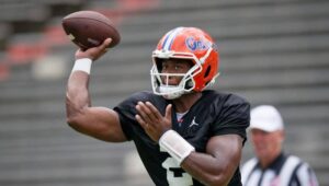 "Florida Gators quarterback practicing a pass during team training session at the stadium"
