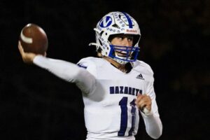 "Nazareth Academy QB number 1 throws a pass during a night football game"