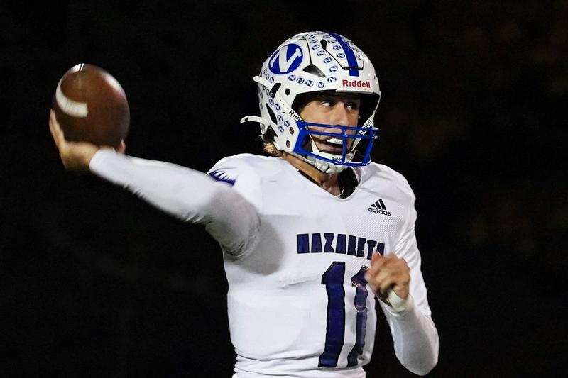 "Nazareth Academy QB number 1 throws a pass during a night football game"