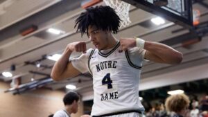 "Notre Dame basketball player number 4 flexes muscles during a competitive game moment"