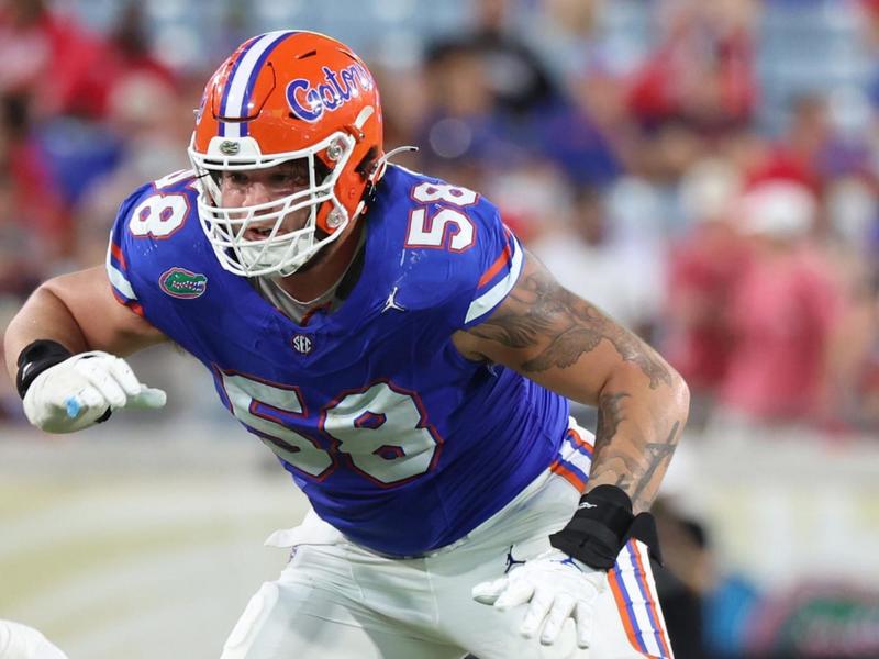 "Florida Gators linebacker ready in stance during a crucial SEC football game"