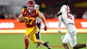 "USC Trojans tight end running with the ball against Stanford during a college football game"