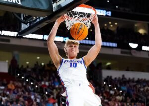 "Florida basketball player number 10 executes a dunk during a game, highlighting Florida NBA Draft returnees."