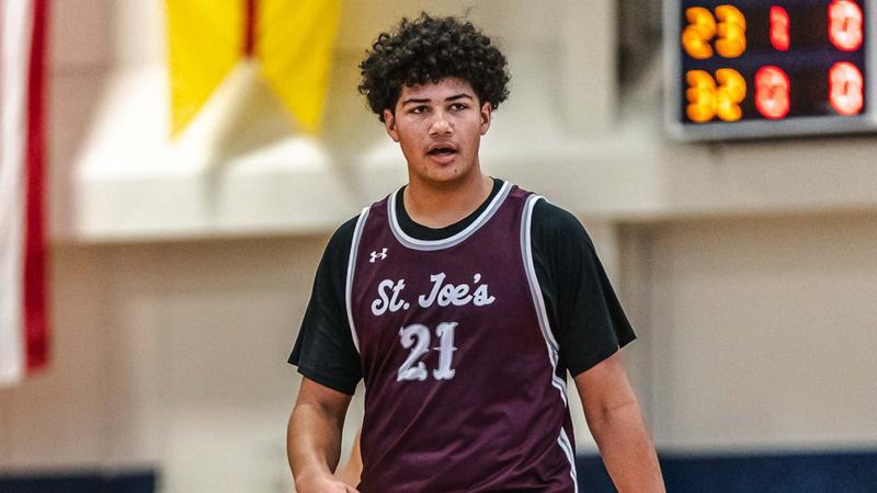 "St. Joe's basketball player number 21 walking on the court during a game break"