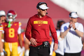 "USC coach overseeing players during a focused team practice session"