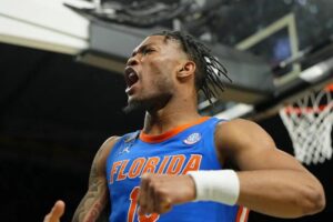 "Florida Gators basketball player celebrates a key play, showcasing the intensity of SEC basketball rankings tiers."