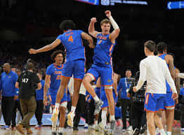 "Florida Gators basketball player celebrates a win, featured in ESPN preseason rankings."