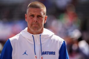 "Billy Napier wearing Florida Gators apparel during a sunny game day event"