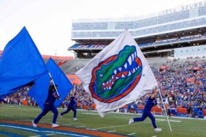 "Florida Gators enthusiasts wave team flags at a home game celebrating the Florida 2025 win total."