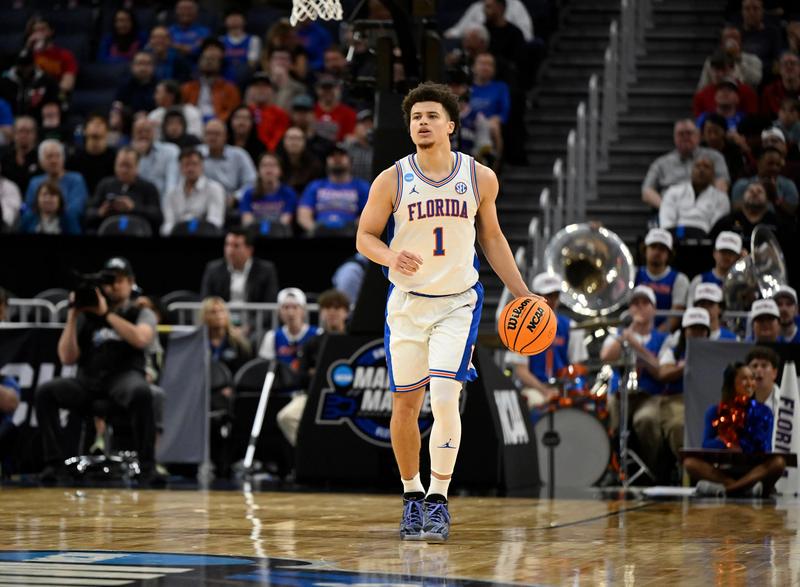 "Walter Clayton dribbling for Florida Gators during an NCAA basketball game, potential NBA Draft pick."