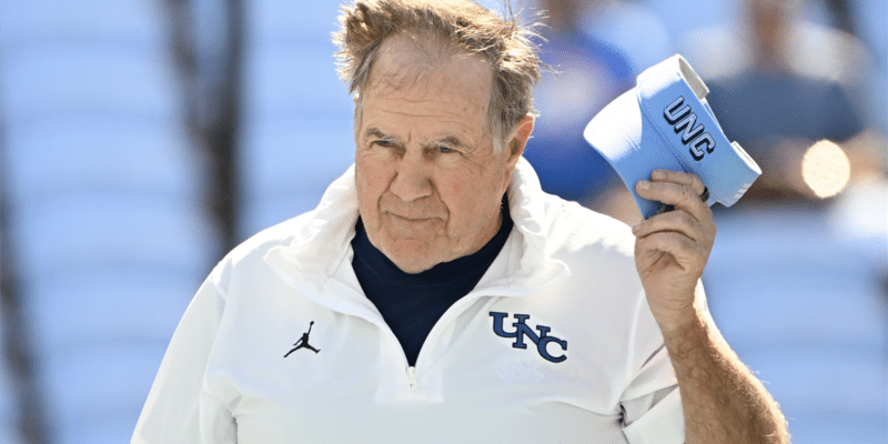 UNC Football Recruiting coach speaks into megaphone at an outdoor training session